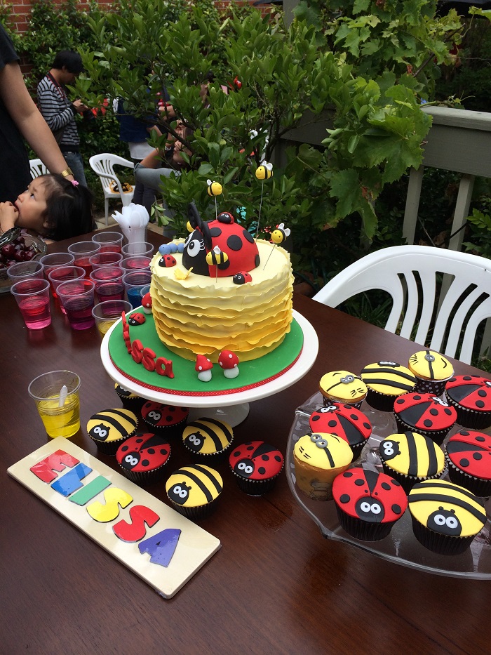 yellow ruffle cake with giant ladybug