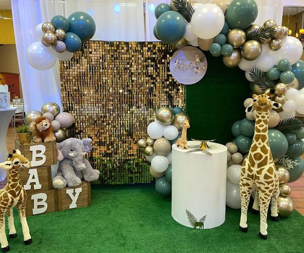 green and gold zoo themed baby shower setup