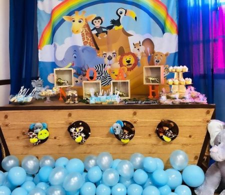 wooden Noahs ark dessert table with blue balloon waves