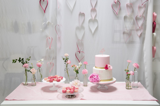 dessert table with hanging paper hearts