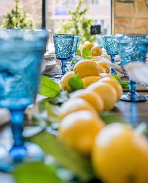 lemon running across tables with beautiful decorative blue glasses