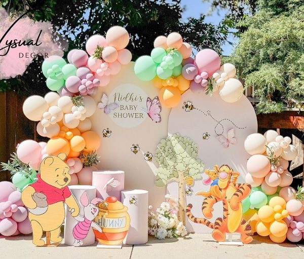 whimsical winnie the pooh baby shower props and balloon garland