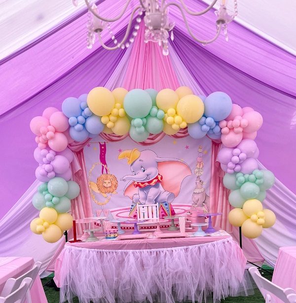 pretty pink and pastel dumbo themed baby shower dessert table and setup